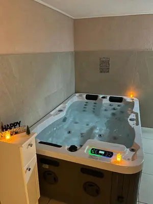 a large jacuzzi tub in a room with lights at VILLA M Rustic & Spa in Slatina Varoš