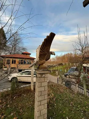 a statue of a bird on a brick pillar at VILLA M Rustic & Spa in Slatina Varoš