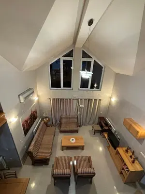 a living room with couches and a table and windows at VILLA M Rustic & Spa in Slatina Varoš