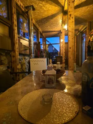 a table with a bottle on top of it at Apartmani Planinsko srce Vlašić in Vlasic