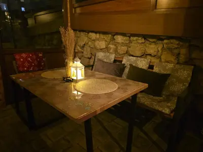 a table with a candle on top of it at Apartmani Planinsko srce Vlašić in Vlasic