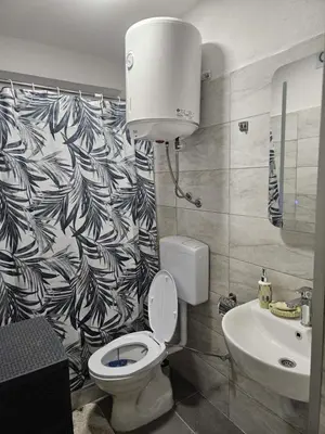 a bathroom with a toilet and a sink at Apartmani Planinsko srce Vlašić in Vlasic