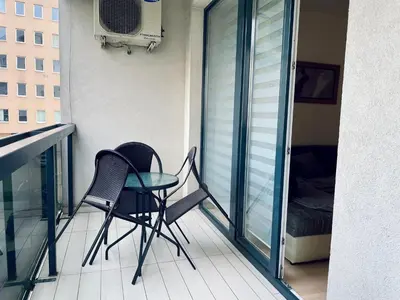 a balcony with two chairs and a table on it at Stan Na Dan - Bewo River Apartments Banja Luka in Rebrovac