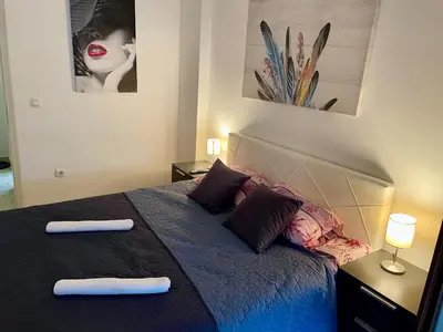 a bedroom with a bed with two towels on it at Stan Na Dan - Bewo River Apartments Banja Luka in Rebrovac