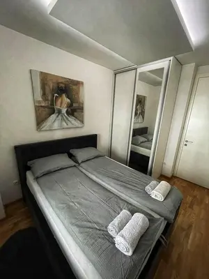 a bedroom with a bed with two pillows and a mirror at Parkpoint in Banja Luka