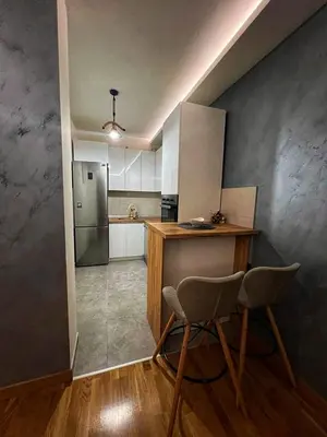 a kitchen with a counter and a table and chairs at Parkpoint in Banja Luka