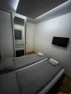 a bedroom with a bed with a mirror and a tv at Parkpoint in Banja Luka