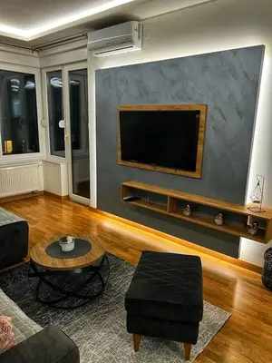 a living room with a flat screen tv on a wall at Parkpoint in Banja Luka