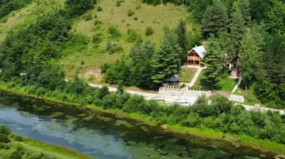 a house on a hill next to a river at LAna in Šipovo