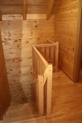 a staircase in a log cabin with wooden walls at LAna in Šipovo