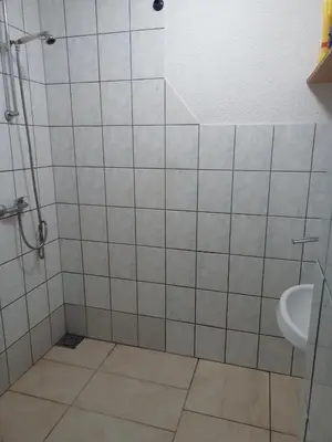 a bathroom with a shower and a sink at Apartman SM IK 1 in Tomislavgrad