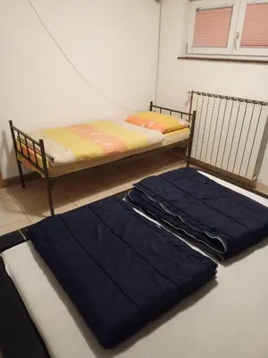 a bedroom with a bunk bed with blue sheets at Apartman SM IK 1 in Tomislavgrad