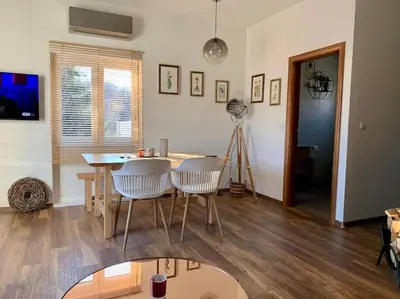 a dining room with a table and two chairs at Sokograd Loft in Šipovo