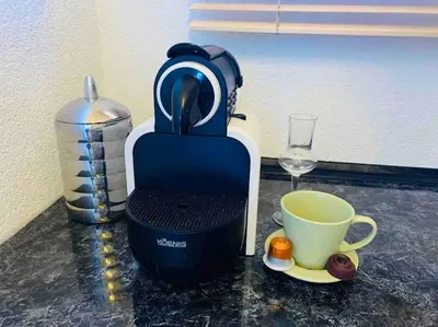 a coffee maker and a cup on a counter at Sokograd Loft in Šipovo