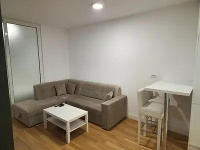 a living room with a couch and a table at Apartment 4th. Floor II in Banja Luka