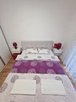 a bedroom with a purple bed with two pillows at Apartment 4th. Floor II in Banja Luka