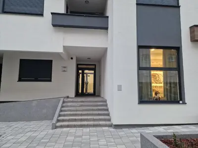 a white building with stairs leading to a door at Apartment 4th. Floor II in Banja Luka