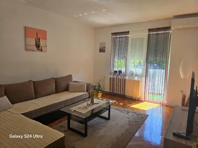 a living room with a couch and a coffee table at Apartman PARK in Bihać