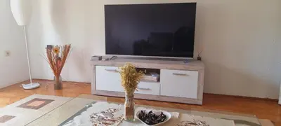 a living room with a television on a table at Apartman PARK in Bihać