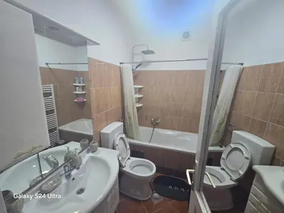 a bathroom with a sink and a toilet and a tub at Apartman PARK in Bihać