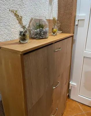 a wooden cabinet with two vases on top of it at Apartman PARK in Bihać