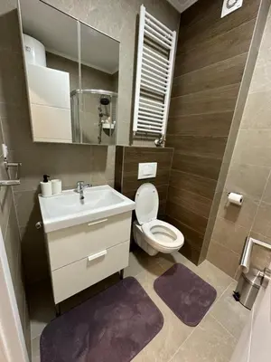 a bathroom with a toilet and a sink and a mirror at Apartman Besta in Banja Luka