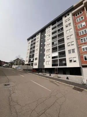an empty street in front of a large building at Apartman Besta in Banja Luka
