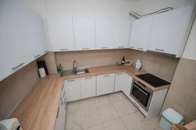 an overhead view of a kitchen with white cabinets at City Museum 2 Apartments Banja Luka in Banja Luka