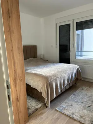 a bedroom with a bed and a window at D&ALux apartman in Banja Luka