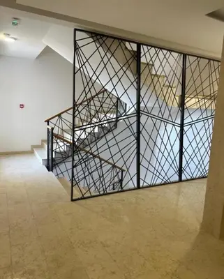 a large glass door in a room with a staircase at D&ALux apartman in Banja Luka