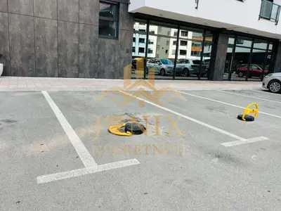 a parking lot with some graffiti on the ground at D&ALux apartman in Banja Luka