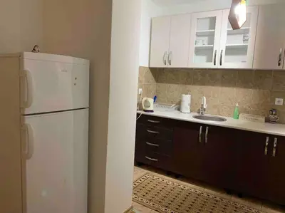 a kitchen with a white refrigerator and a sink at Darija's place in Banja Luka