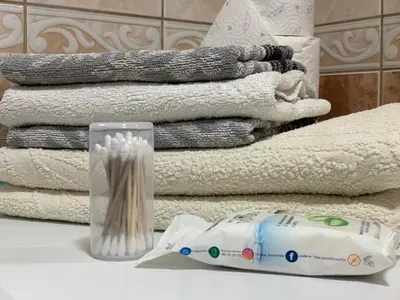a pile of towels and a vase on a table at Darija's place in Banja Luka
