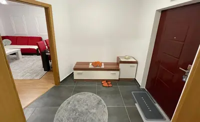 a living room with a table and a red couch at HG3 Jelah Stan na Dan in Jelah