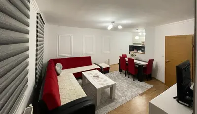 a living room with a red couch and a table at HG3 Jelah Stan na Dan in Jelah