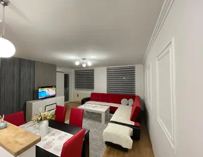 a living room with a red couch and red chairs at HG3 Jelah Stan na Dan in Jelah
