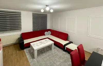 a living room with a red couch and a table at HG3 Jelah Stan na Dan in Jelah