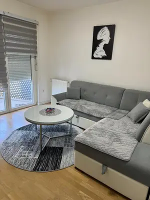 a living room with a couch and a table at Amina in Tuzla