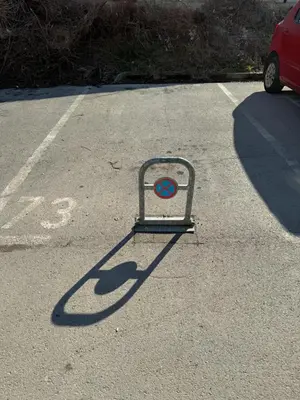 a sign in the middle of a parking lot at Amina in Tuzla
