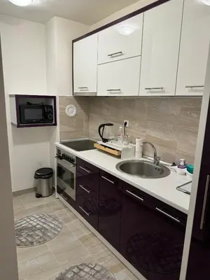 a kitchen with a sink and a microwave at Amina in Tuzla