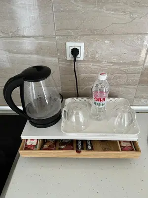 a counter top with a bottle of water and a blender at Amina in Tuzla
