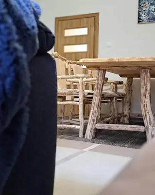 a wooden table and chairs in a room at Apartman Maximus in Kupres
