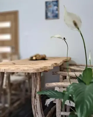 a wooden table with a flower on top of it at Apartman Maximus in Kupres