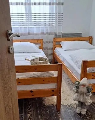 a bedroom with two bunk beds and a stuffed animal at Apartman Maximus in Kupres