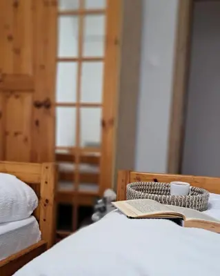 a bedroom with a bed with a book and a coffee cup at Apartman Maximus in Kupres