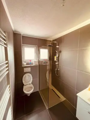 a small bathroom with a toilet and a shower at Kuca za odmor Nedo in Kupres