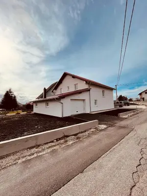 a white house sitting on the side of a road at Kuca za odmor Nedo in Kupres