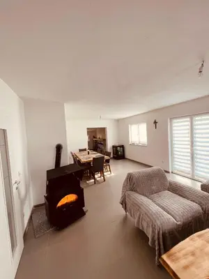 a living room with a couch and a fireplace at Kuca za odmor Nedo in Kupres