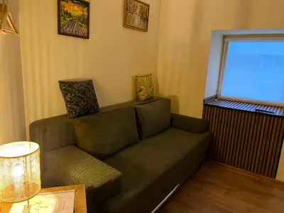 a living room with a couch and a window at Vila Dvorište in Banja Luka