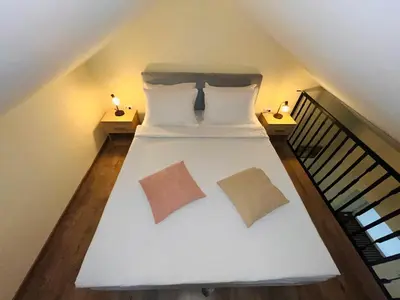 a bedroom with a white bed with two pillows at Vila Dvorište in Banja Luka